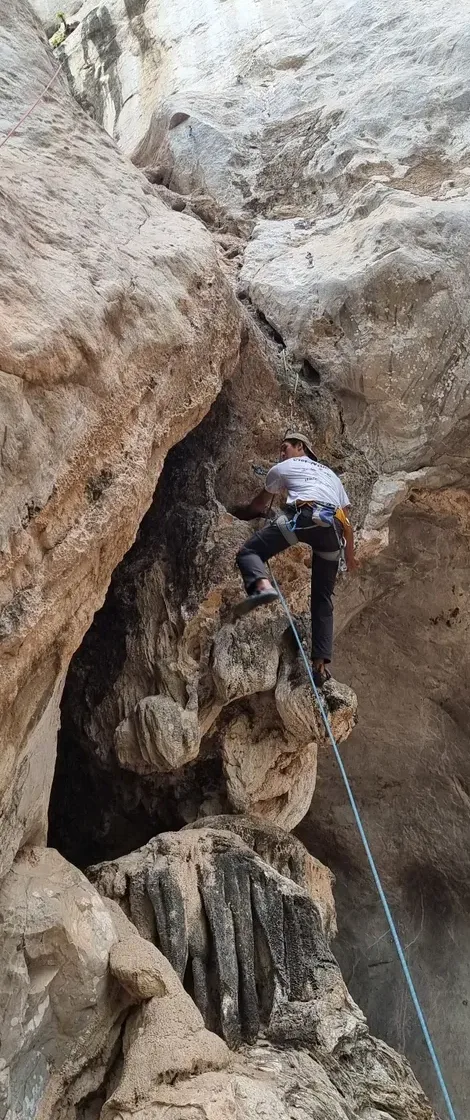 Lead climbing on a tall limestone wall